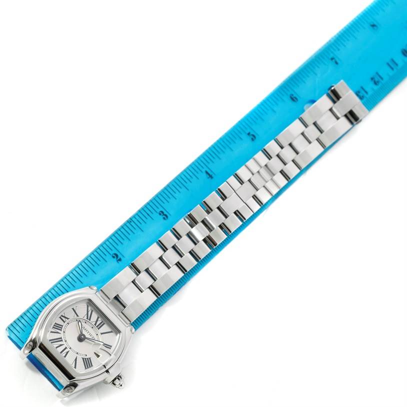 The image shows a top-down view of a Cartier Roadster W62016V3 Women's Stainless Steel Silver Dial W62016V3 Women's Stainless Steel Silver Dial watch, displaying the face and the linked stainless steel band alongside a ruler.