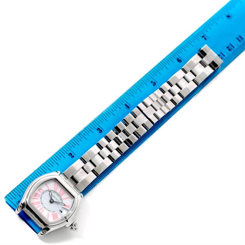This image shows a Cartier Roadster W6206006 Women's Stainless Steel Mother of Pearl Dial W6206006 Women's Stainless Steel Mother of Pearl Dial watch placed diagonally next to a ruler, displaying the watch face and metal bracelet.