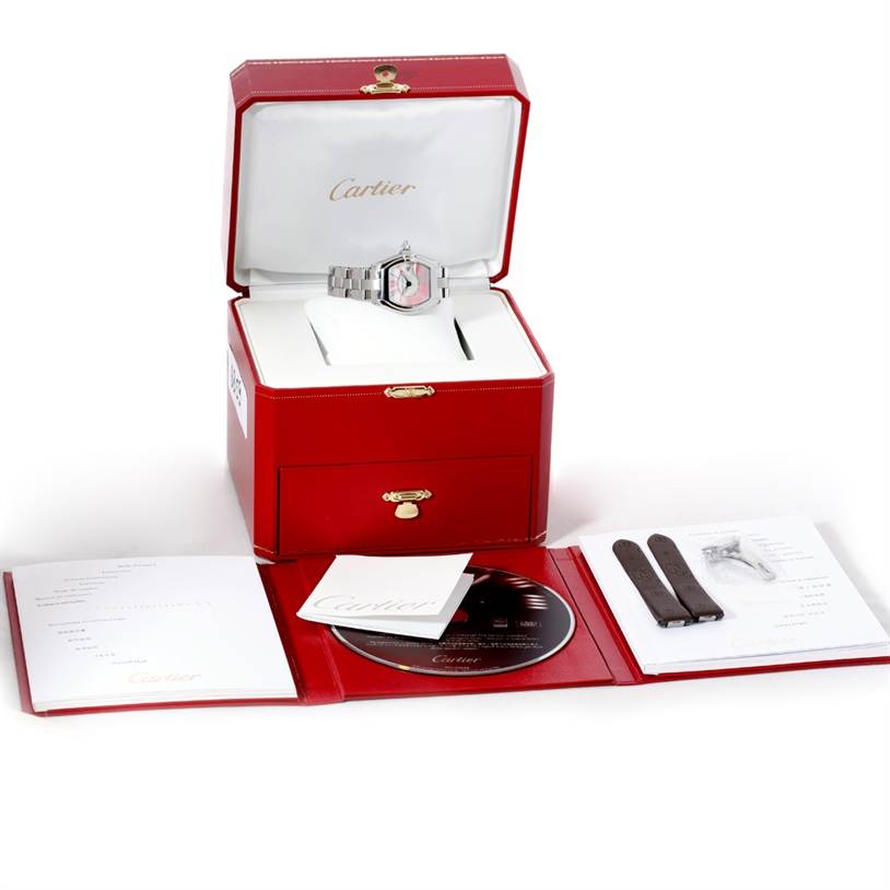 The image shows a Cartier Roadster W6206006 Women's Stainless Steel Mother of Pearl Dial W6206006 Women's Stainless Steel Mother of Pearl Dial watch in its open red box with additional straps, a CD, and documentation displayed.