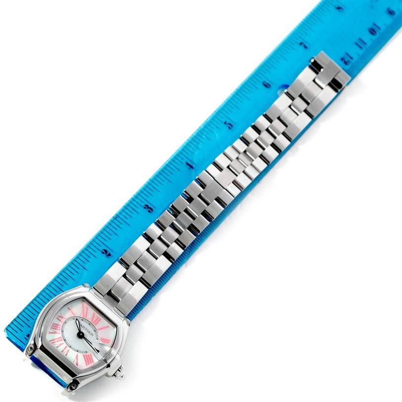 The Cartier Roadster W6206006 Women's Stainless Steel Mother of Pearl Dial W6206006 Women's Stainless Steel Mother of Pearl Dial watch is shown at a top-down angle, displaying the face and metal bracelet next to a ruler.