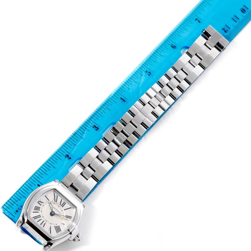The Cartier Roadster W62016V3 Women's Stainless Steel Silver Dial W62016V3 Women's Stainless Steel Silver Dial watch is displayed flat, showing the face, bracelet, and a ruler for measurement.