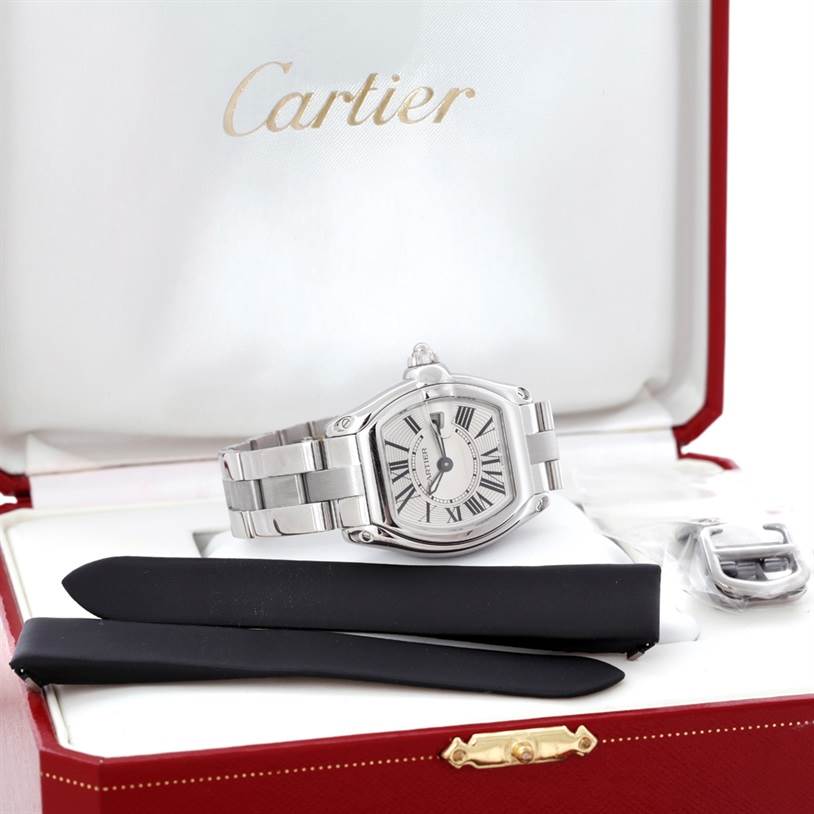 The Cartier Roadster W62016V3 Women's Stainless Steel Silver Dial W62016V3 Women's Stainless Steel Silver Dial watch is shown in its box with additional straps and a clasp.