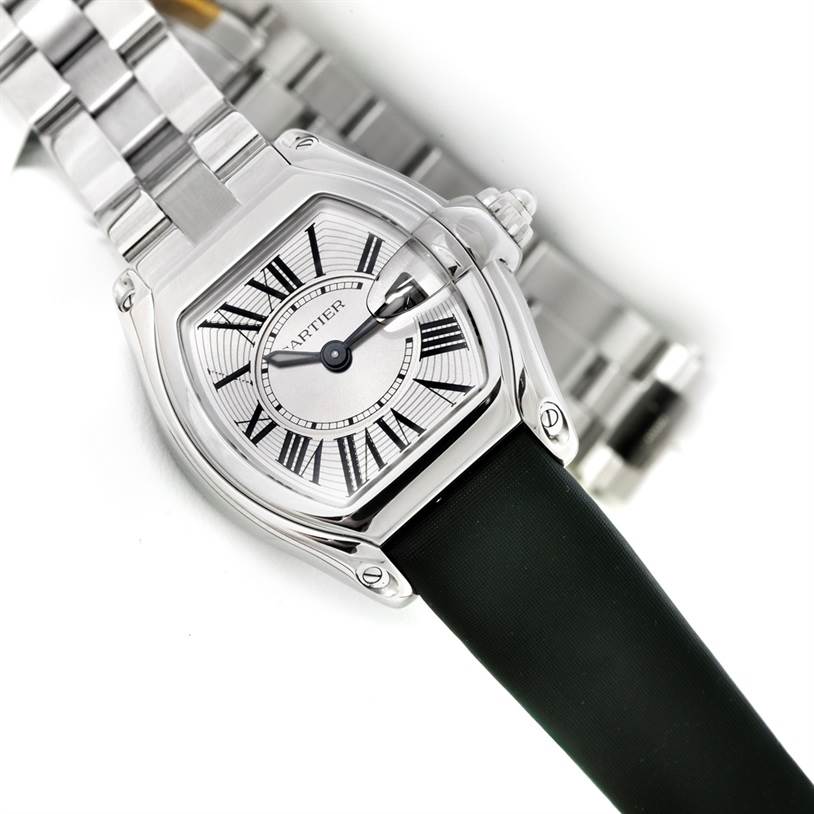 The image shows a top-down view of a Cartier Roadster W62016V3 Women's Stainless Steel Silver Dial W62016V3 Women's Stainless Steel Silver Dial watch with both a metal and black strap visible.