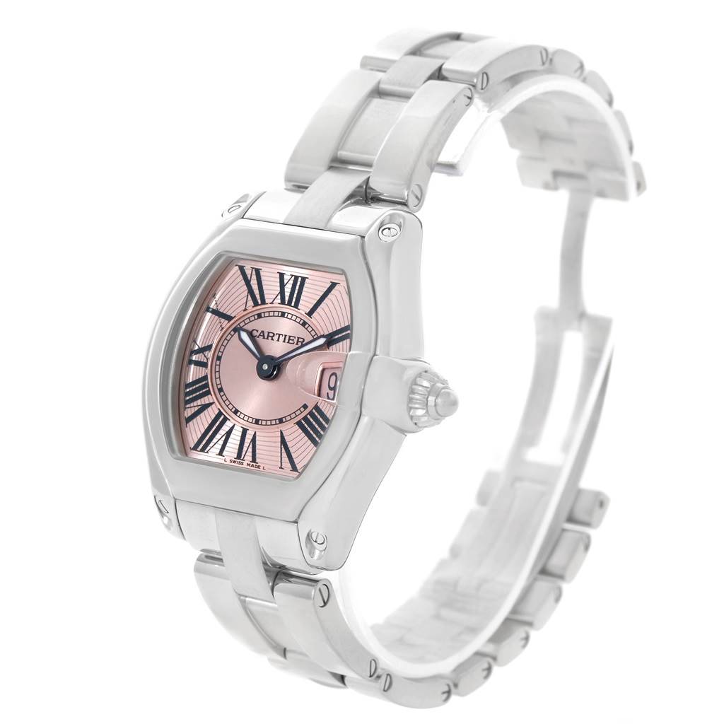 This image shows a Cartier Roadster W62017V3 Women's Stainless Steel Pink Dial W62017V3 Women's Stainless Steel Pink Dial watch featuring a pink dial, Roman numerals, and a metal bracelet from a slight angle.