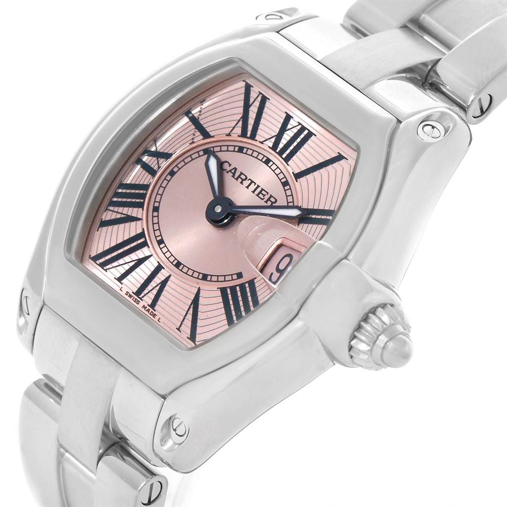 The image shows a close-up angle of a Cartier Roadster W62017V3 Women's Stainless Steel Pink Dial W62017V3 Women's Stainless Steel Pink Dial watch displaying its face, bezel, and part of the bracelet.