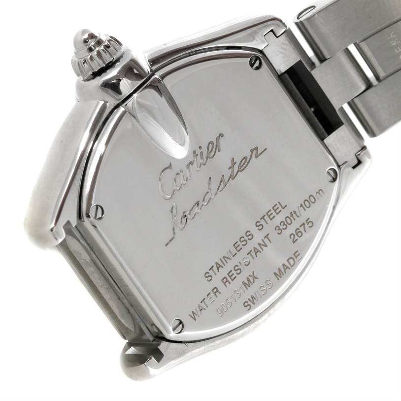 The image shows the back case and part of the bracelet of a Cartier Roadster W62016V3 Women's Stainless Steel Silver Dial W62016V3 Women's Stainless Steel Silver Dial watch, highlighting its inscriptions and crown.