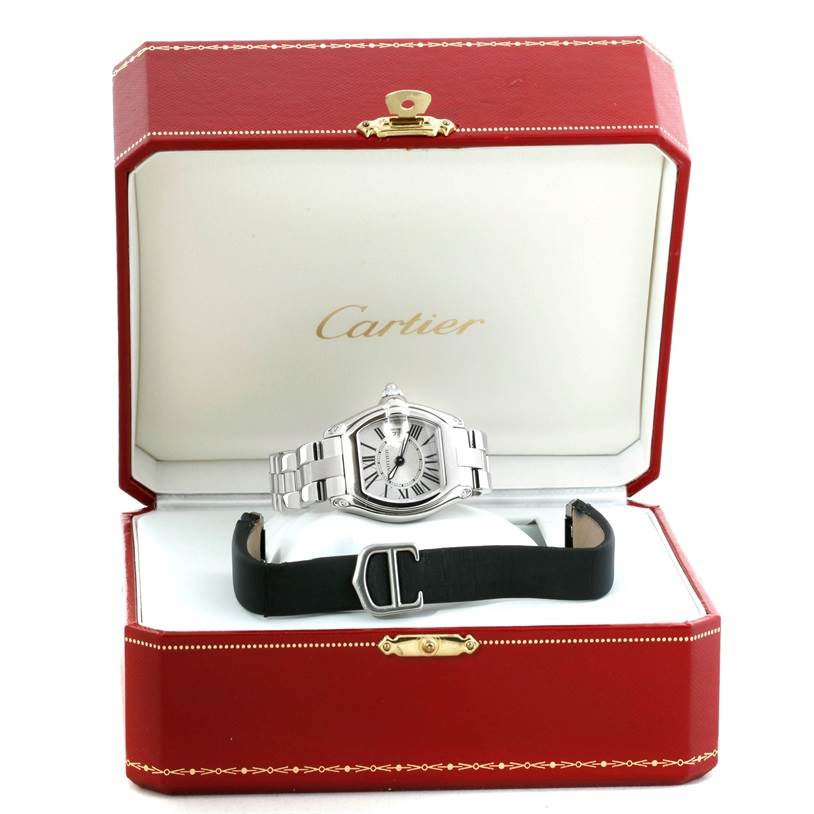 The Cartier Roadster W62016V3 Women's Stainless Steel Silver Dial W62016V3 Women's Stainless Steel Silver Dial watch is displayed front-on in its box, with an additional strap accessory shown.