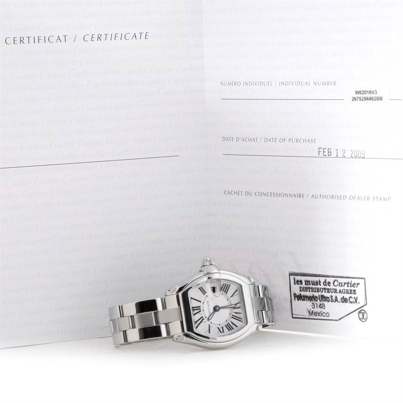 The Cartier Roadster W62016V3 Women's Stainless Steel Silver Dial W62016V3 Women's Stainless Steel Silver Dial watch is shown at an oblique angle with its certificate, focusing on the face, bracelet, and clasp.