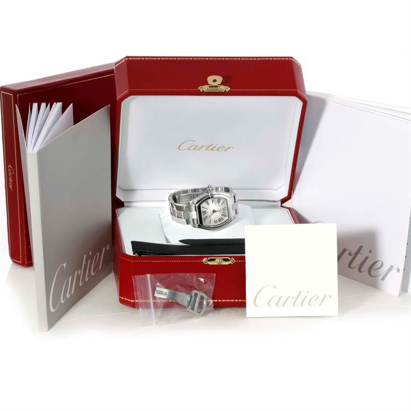 The Cartier Roadster W62016V3 Women's Stainless Steel Silver Dial W62016V3 Women's Stainless Steel Silver Dial watch is shown front-on, with its box, manuals, and an additional clasp or link.