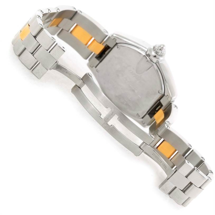 This image shows the back of the Cartier Roadster W62026Y4 Women's Steel and Gold (two tone) Silver Dial W62026Y4 Women's Steel and Gold (two tone) Silver Dial watch and its partially open metallic bracelet.