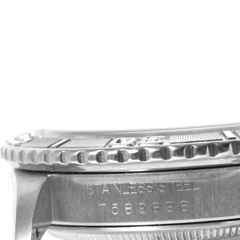 The image shows a close-up side view of the bezel and case side of the Rolex Turn-o-Graph 16264 Men's Stainless Steel Blue Dial 16264 Men's Stainless Steel Blue Dial, highlighting the serial number and "stainless steel" engraving.