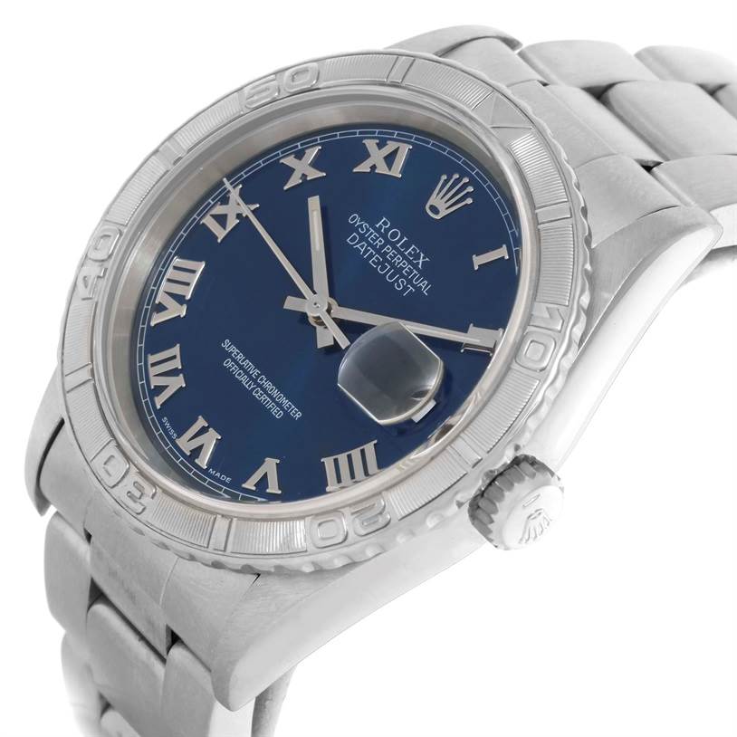 The image shows a Turn-o-Graph Rolex watch from a top-side angle, highlighting its blue dial, metallic band, and bezel.