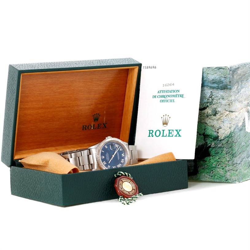 The Rolex Turn-o-Graph 16264 Men's Stainless Steel Blue Dial 16264 Men's Stainless Steel Blue Dial watch is shown inside its open green box, with accompanying documentation and a tag.