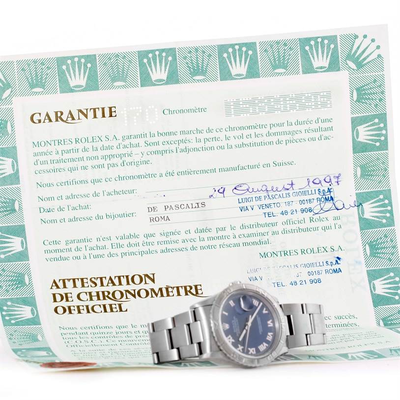 The Rolex Turn-o-Graph 16264 Men's Stainless Steel Blue Dial 16264 Men's Stainless Steel Blue Dial watch is shown from a side angle along with its official warranty and chronometer certification.