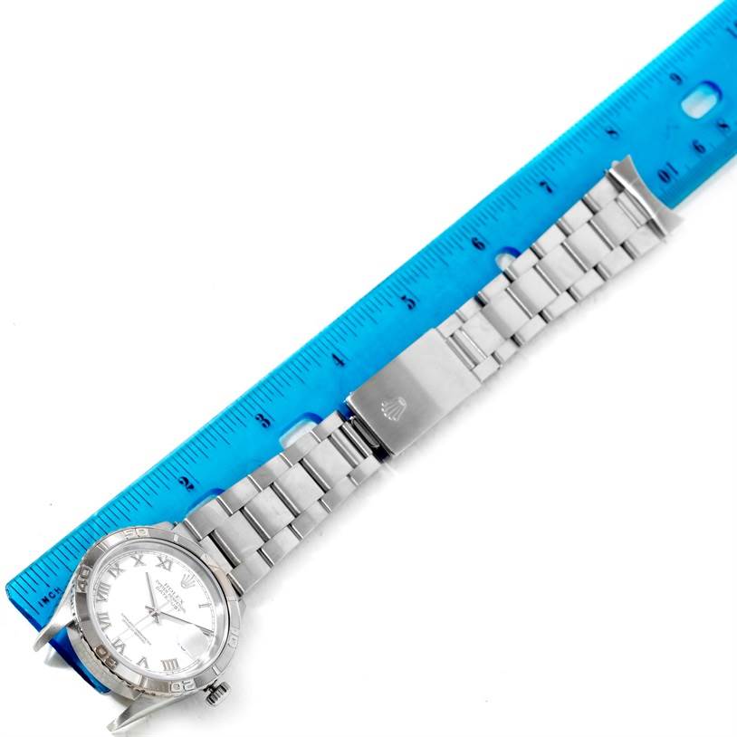 The image shows a Rolex Turn-o-Graph 16264 Men
s Stainless Steel White Dial 16264 Men
s Stainless Steel White Dial watch laying flat next to a blue ruler, highlighting the watch face, bracelet, and clasp.