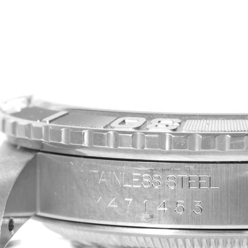 The image shows a close-up side view of a Rolex Turn-o-Graph 16264 Men's Stainless Steel Black Dial 16264 Men's Stainless Steel Black Dial watch, displaying its bezel and engraved serial number on the stainless steel case.