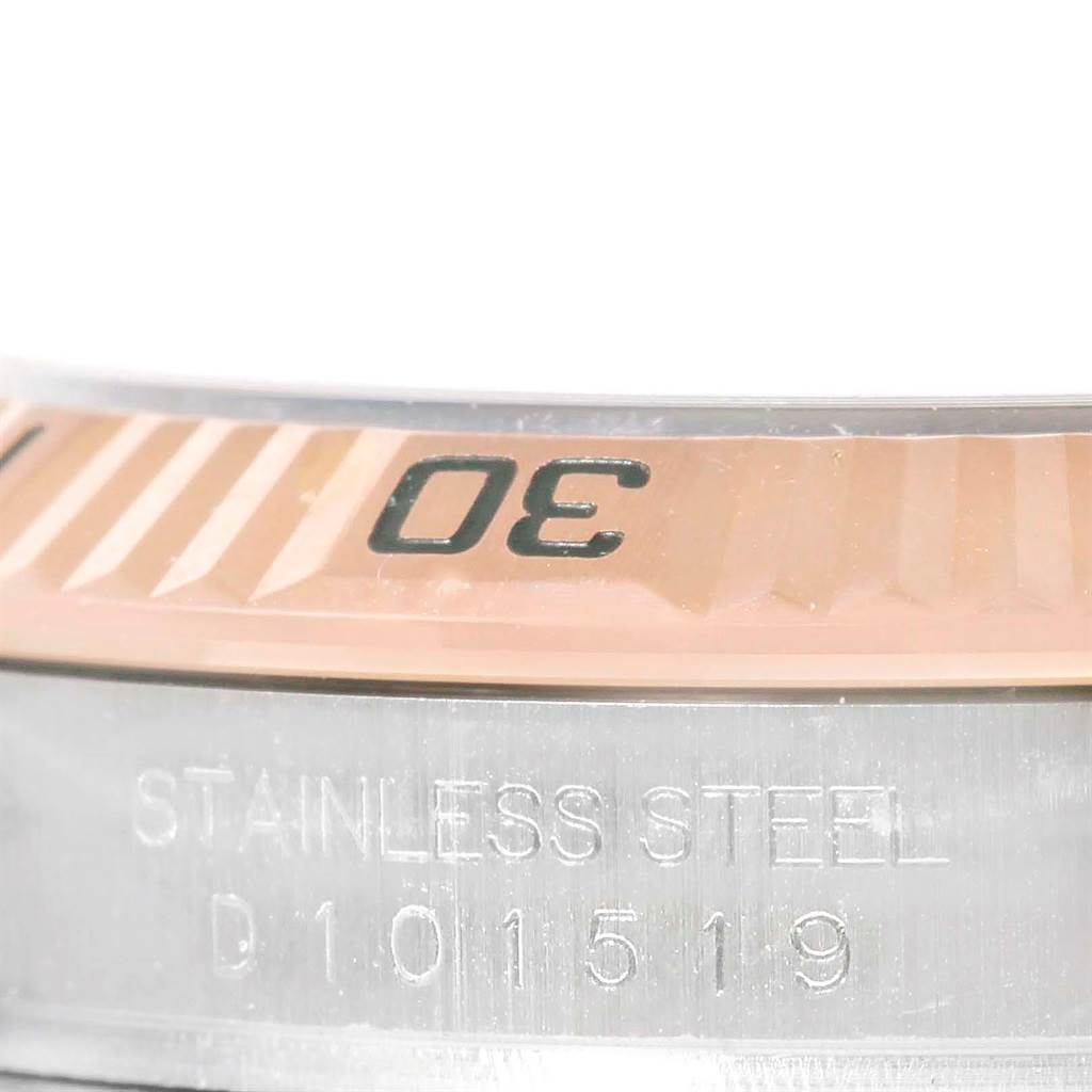 This close-up image shows the stainless steel casing and partial bezel with markings of a Rolex Turn-o-Graph 116261 Men's Stainless Steel Black Dial 116261 Men's Stainless Steel Black Dial watch.