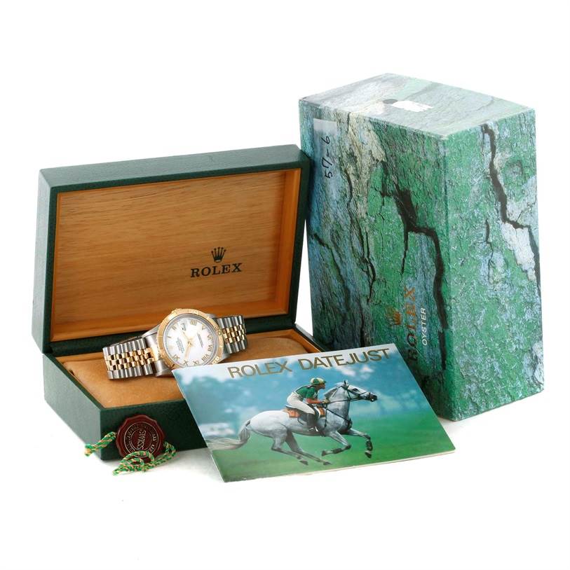 The Rolex Turn-o-Graph 16263 Men's Steel and Gold (two tone) White Dial 16263 Men's Steel and Gold (two tone) White Dial watch is shown in its open box with accompanying accessories like a booklet and tag.