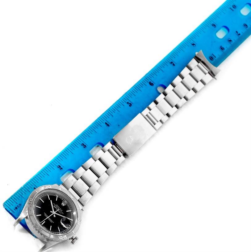 The image shows a top-down view of a Rolex Turn-o-Graph 16264 Men's Stainless Steel Black Dial 16264 Men's Stainless Steel Black Dial watch and its bracelet alongside a blue ruler for measurement.