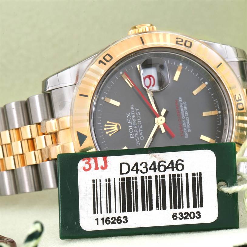 The image shows a close-up angled view of a Rolex Turn-o-Graph 116263GYSJ Men's Steel and Gold (two tone) Grey Dial 116263GYSJ Men's Steel and Gold (two tone) Grey Dial watch, focusing on the bezel, dial, and part of the bracelet.