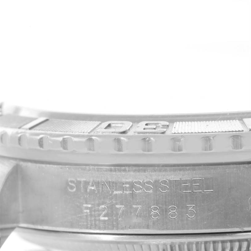 This image shows a close-up of the stainless steel case and bezel of the Rolex Turn-o-Graph 16264 Men's Stainless Steel Silver Dial 16264 Men's Stainless Steel Silver Dial watch, displaying part of its serial number.