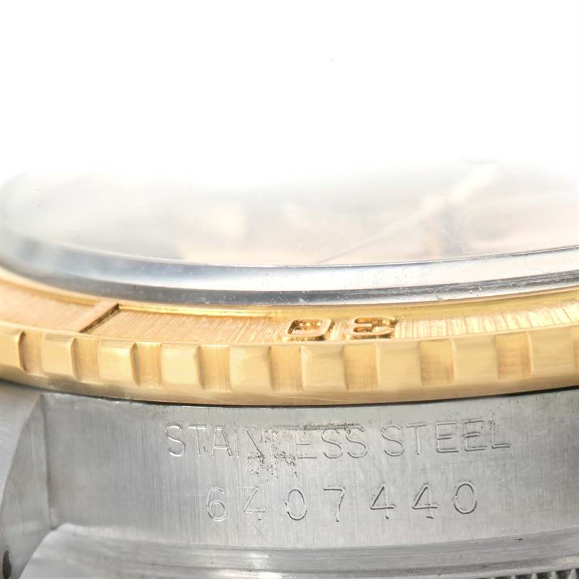 This image shows a close-up view of the side of the Rolex Turn-o-Graph 16263 Men's Steel and Gold (two tone) Champagne Dial 16263 Men's Steel and Gold (two tone) Champagne Dial watch, highlighting the bezel and part of the case with the serial number.