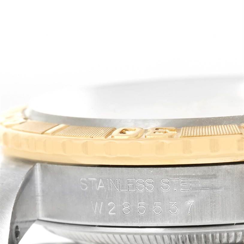 This image shows a close-up angle of the bezel and case of a Turn-o-Graph model by Rolex, highlighting the "Stainless Steel" engraving.