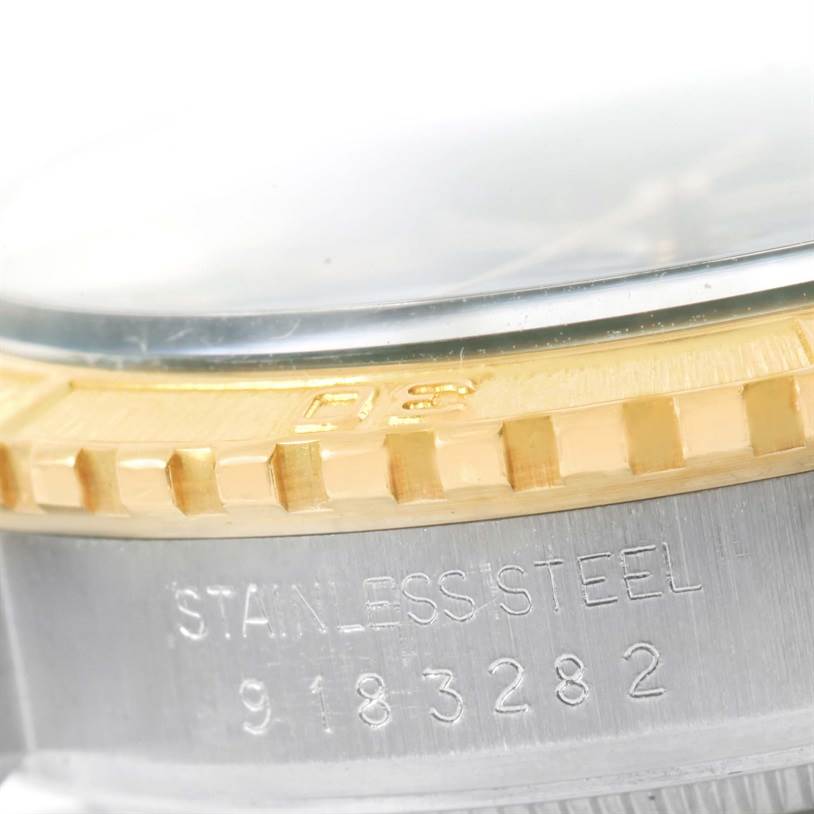This is a close-up of the bezel and case side of a Rolex Turn-o-Graph 16253 Men
s Steel and Gold (two tone) Blue Dial 16253 Men
s Steel and Gold (two tone) Blue Dial watch, showing the stainless steel material and serial number.