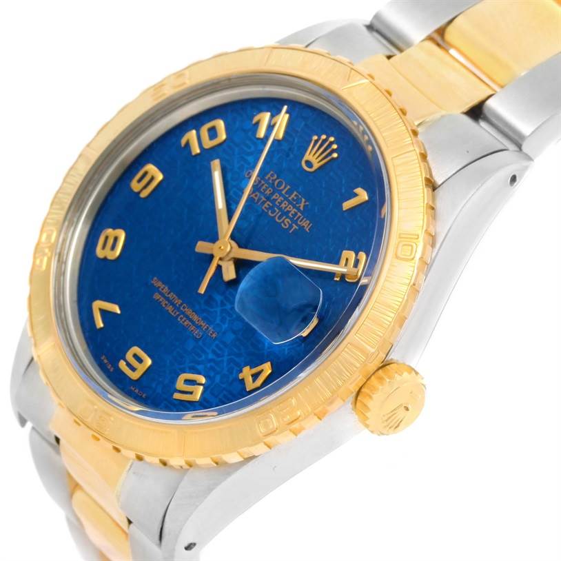 The Rolex Turn-o-Graph 16253 Men
s Steel and Gold (two tone) Blue Dial 16253 Men
s Steel and Gold (two tone) Blue Dial watch is shown at an angle, highlighting its blue dial, gold bezel, and crown.