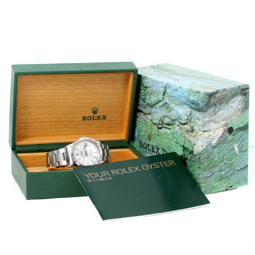 The image shows a Rolex Turn-o-Graph 16264 Men
s Stainless Steel White Dial 16264 Men
s Stainless Steel White Dial watch placed inside its open green and wooden box, accompanied by a manual booklet.