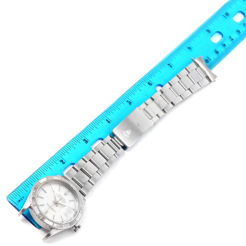 The image shows a Rolex Turn-o-Graph 16264 Men
s Stainless Steel White Dial 16264 Men
s Stainless Steel White Dial watch laid flat next to a ruler, displaying the watch face, bracelet, and clasp.
