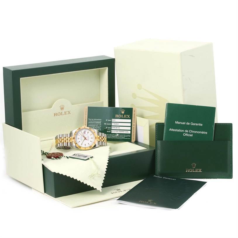 The Rolex Turn-o-Graph 116263 Men's Stainless Steel White Dial 116263 Men's Stainless Steel White Dial watch is shown with its box, guarantee manual, and other accessories from a front-facing angle.