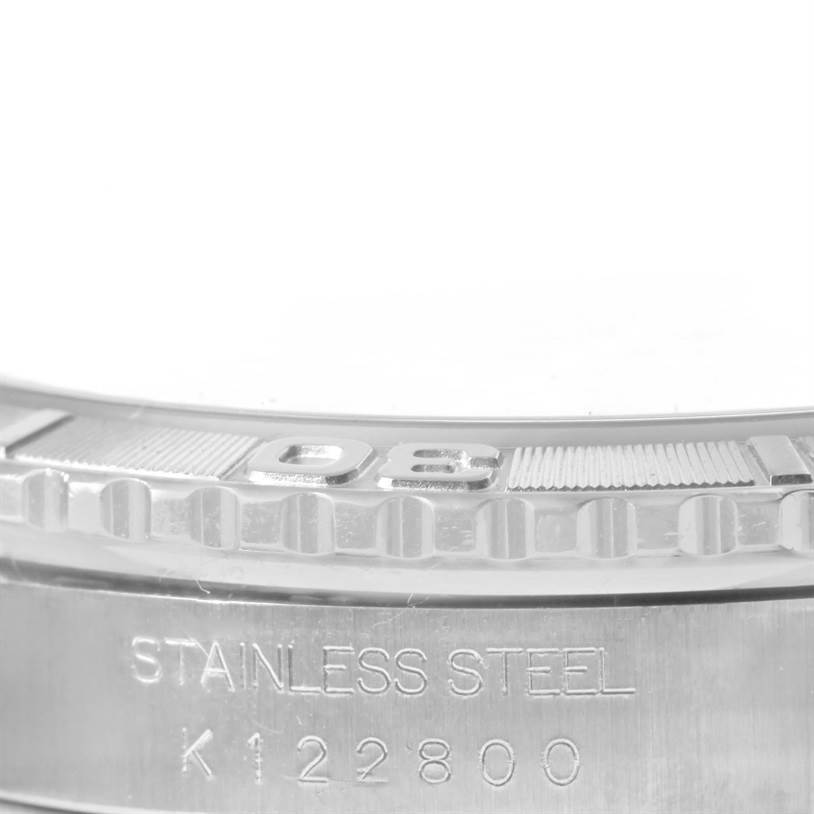 This image shows a close-up of the Rolex Turn-o-Graph 16264 Men's Stainless Steel Black Dial 16264 Men's Stainless Steel Black Dial watch bezel and part of its stainless steel case with serial numbers engraved.