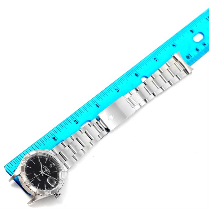 The image shows a Rolex Turn-o-Graph 16264 Men's Stainless Steel Black Dial 16264 Men's Stainless Steel Black Dial watch laid flat next to a ruler, displaying the face, bezel, and full metal bracelet.