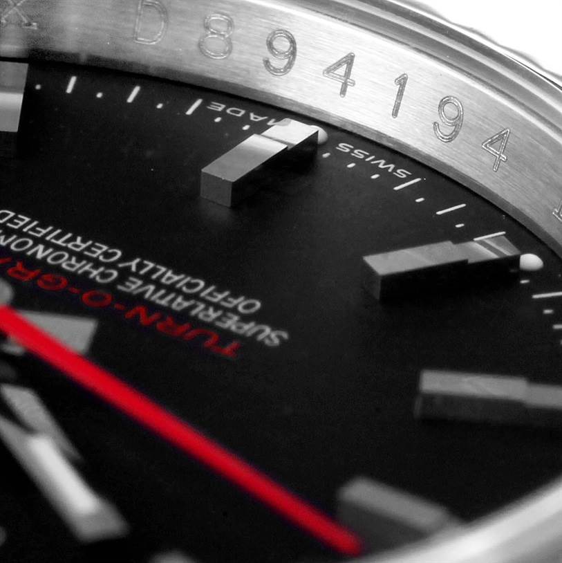 The image shows a close-up view of the dial and markers of a Rolex Turn-o-Graph 116264 Men's Stainless Steel Black Dial 116264 Men's Stainless Steel Black Dial watch, highlighting the model name and bezel engravings.