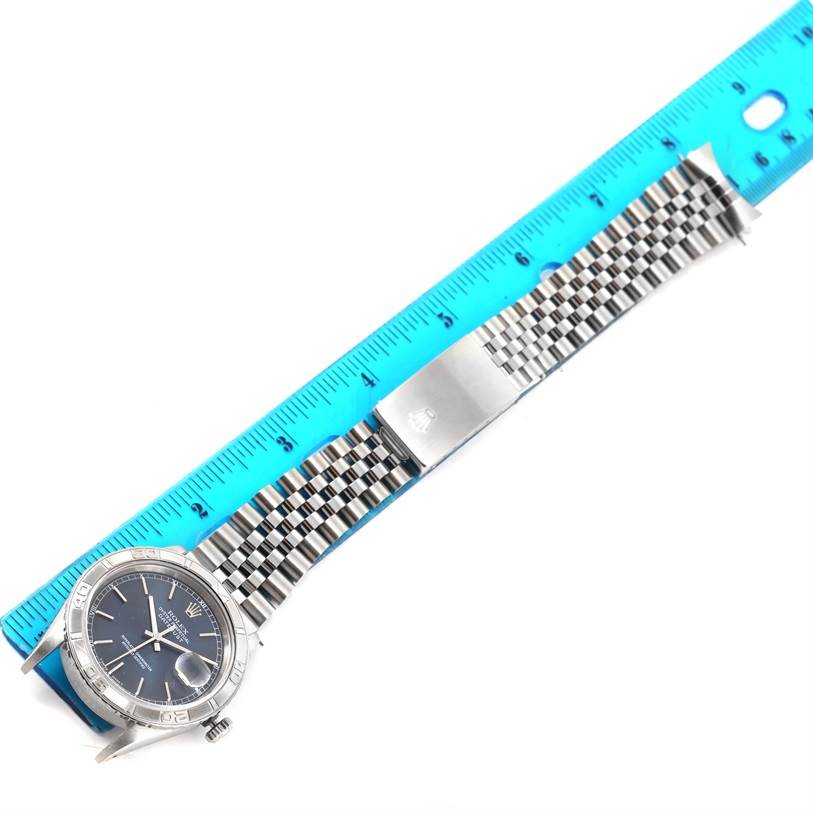 The image shows a Rolex Turn-o-Graph 16264 Men's Stainless Steel Grey Dial 16264 Men's Stainless Steel Grey Dial watch with its face and metal bracelet laid next to a ruler for measurement.