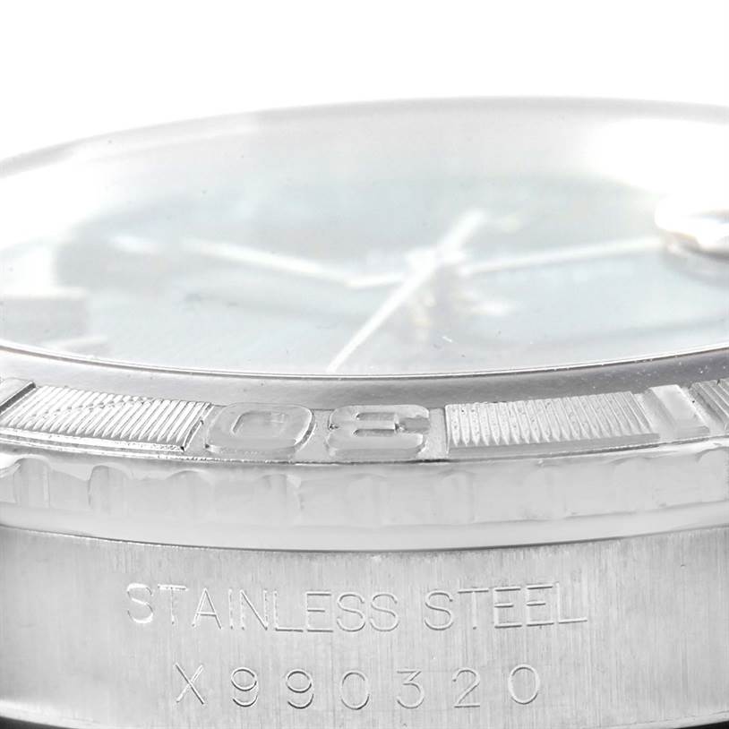 This image shows a close-up side angle of the Rolex Turn-o-Graph 16264 Men's Stainless Steel Grey Dial 16264 Men's Stainless Steel Grey Dial watch's bezel, crystal, and part of the steel casing with engravings.