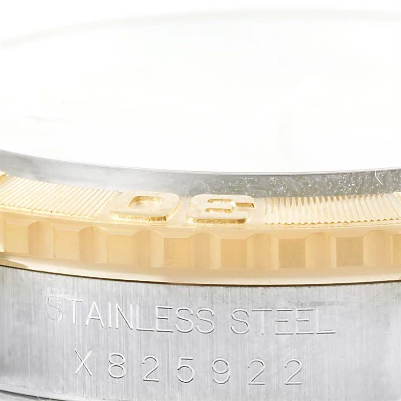 This close-up image shows the bezel and part of the case back of the Rolex Turn-o-Graph 16263 Men's Steel and Gold (two tone) Champagne Dial 16263 Men's Steel and Gold (two tone) Champagne Dial watch, highlighting the serial number and the "Stainless Steel" engraving.