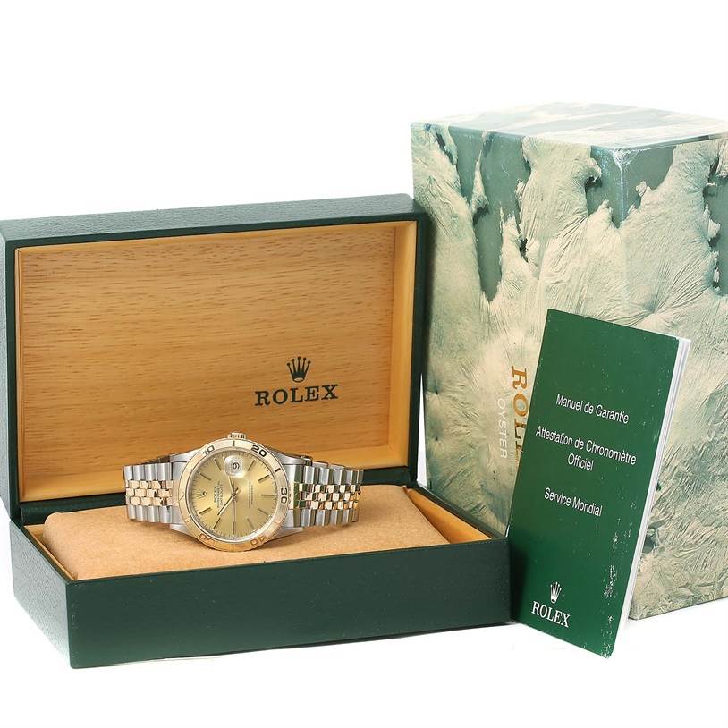 The Rolex Turn-o-Graph 16263 Men's Steel and Gold (two tone) Champagne Dial 16263 Men's Steel and Gold (two tone) Champagne Dial watch is displayed in its open box, accompanied by a green warranty manual and the outer packaging.