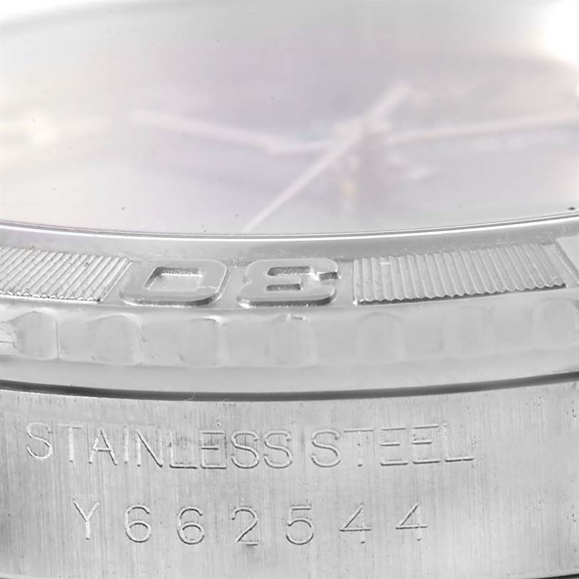 The image shows a close-up of the bezel and case of a Rolex Turn-o-Graph 16264 Men's Stainless Steel Blue Dial 16264 Men's Stainless Steel Blue Dial watch, highlighting the stainless steel engraving and serial number.