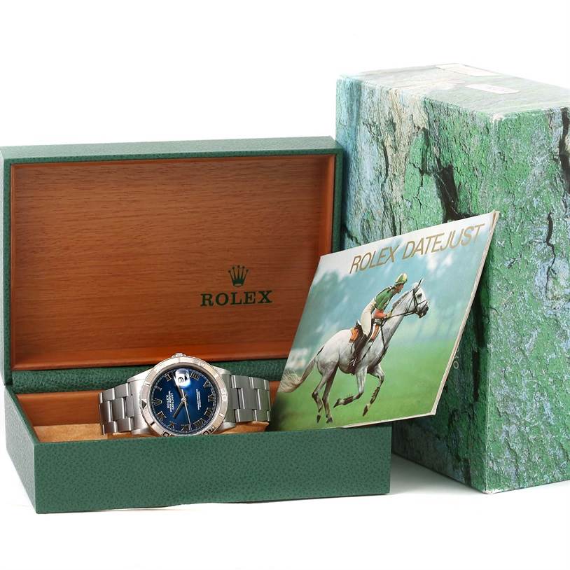 The image shows a Rolex Turn-o-Graph 16264 Men's Stainless Steel Blue Dial 16264 Men's Stainless Steel Blue Dial watch with a blue dial inside an open green and wood watch box, alongside its booklet.