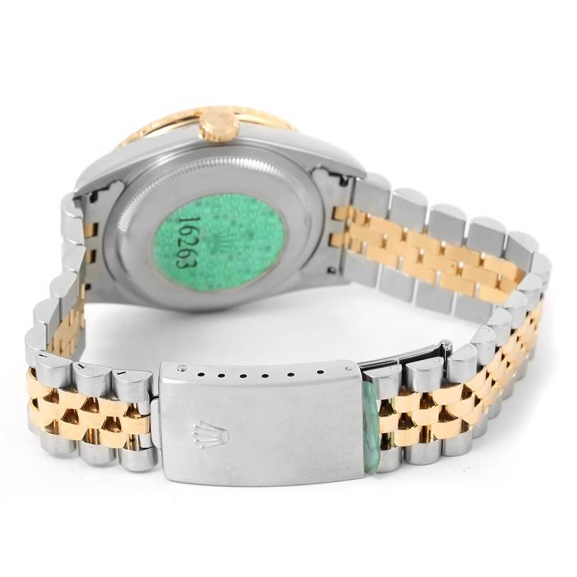 This is the back view of a Rolex Turn-o-Graph 16263 Men
s Steel and Gold (two tone) Black Dial 16263 Men
s Steel and Gold (two tone) Black Dial watch showing its clasp, case back, and bracelet.