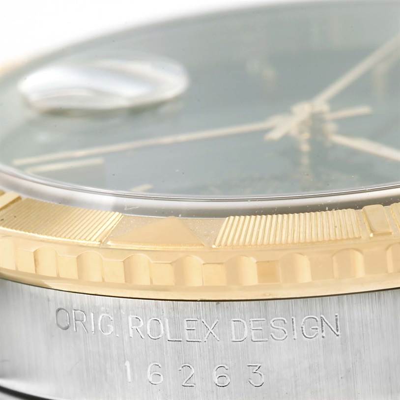 The image shows a close-up of the bezel and part of the case side of a Rolex Turn-o-Graph 16263 Men
s Steel and Gold (two tone) Black Dial 16263 Men
s Steel and Gold (two tone) Black Dial watch, including inscription details.