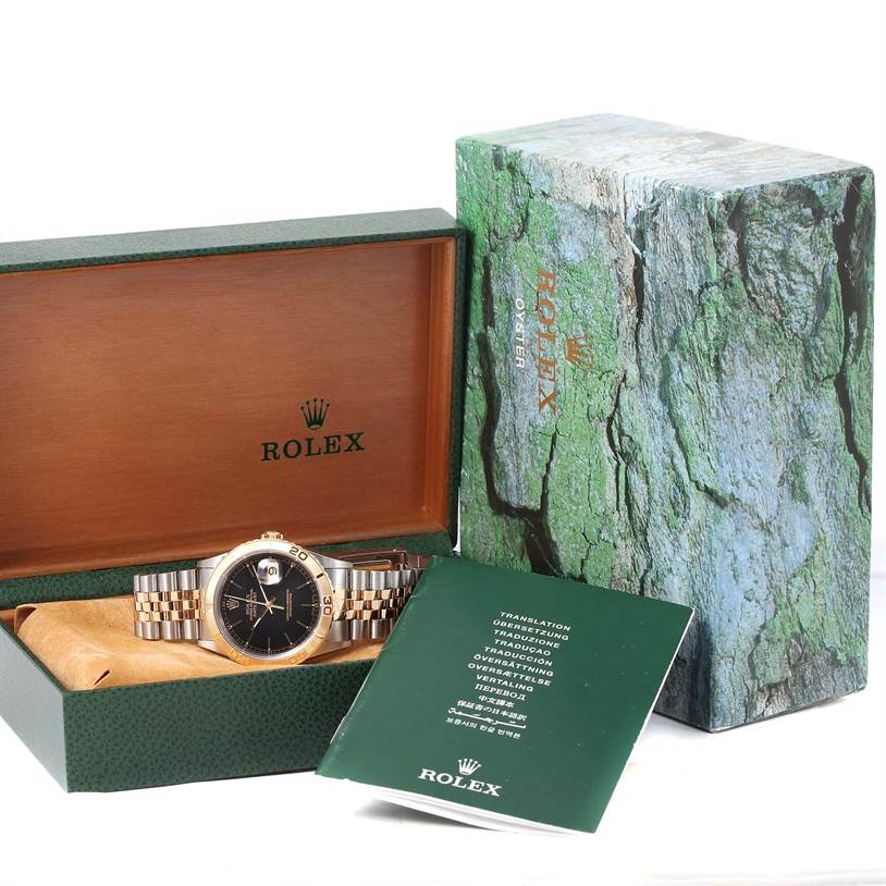 The image shows the Rolex Turn-o-Graph 16263 Men
s Steel and Gold (two tone) Black Dial 16263 Men
s Steel and Gold (two tone) Black Dial watch with its box and manual, viewed from the front with the watch face and bracelet displayed.