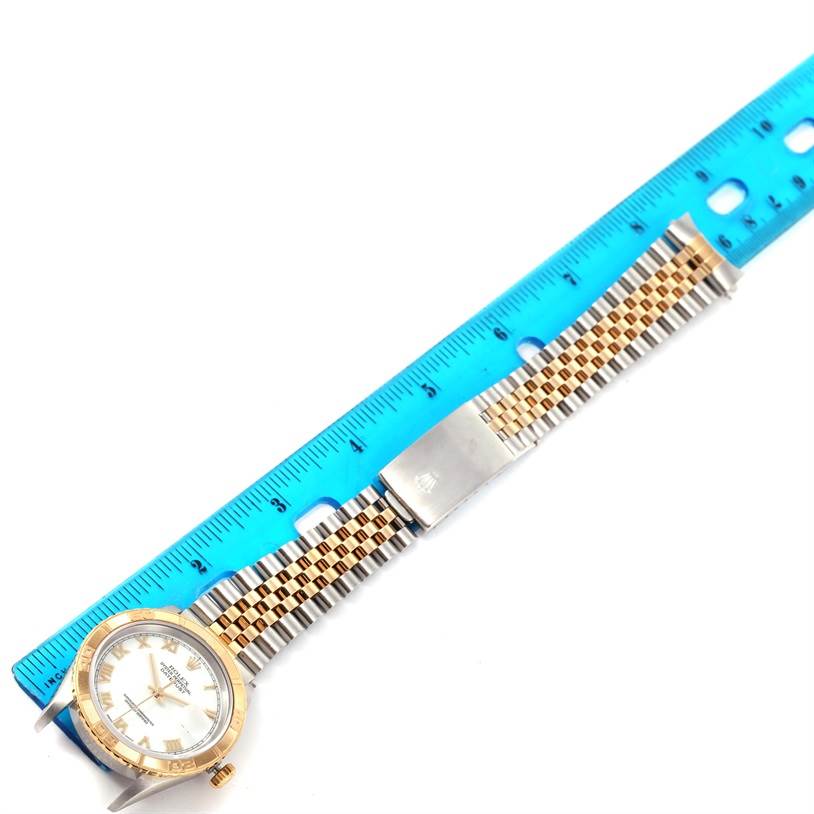 The image shows a Rolex Turn-o-Graph 16263 Men's Steel and Gold (two tone) White Dial 16263 Men's Steel and Gold (two tone) White Dial watch laid flat next to a ruler for measurement, highlighting the face and band.