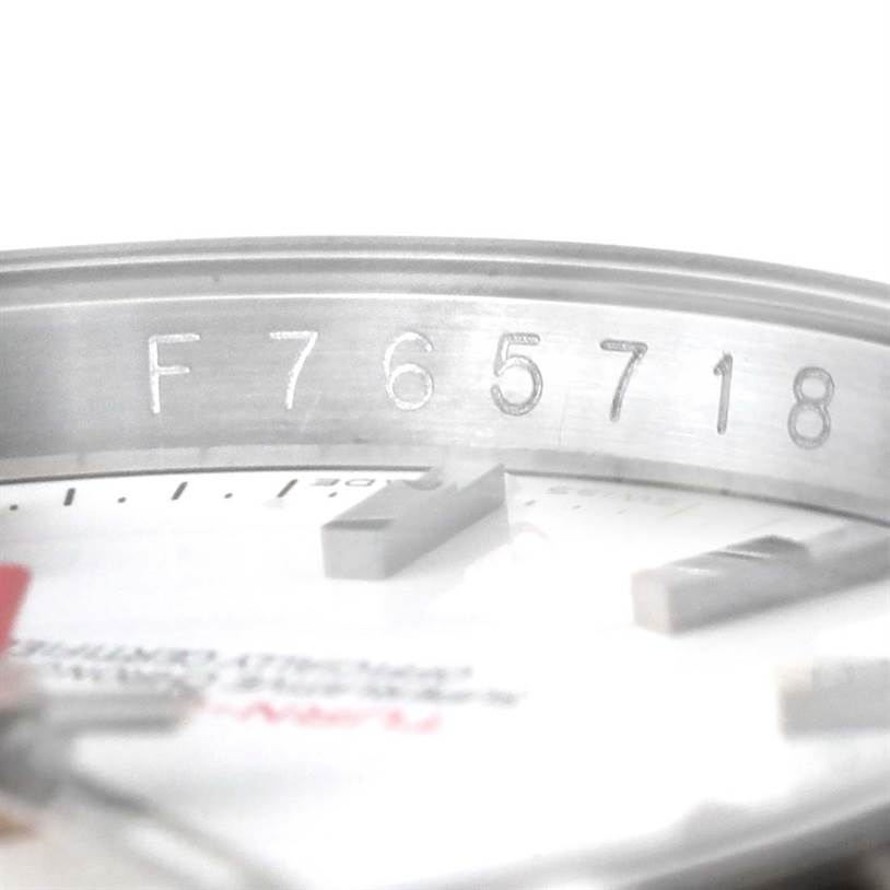 The image shows a close-up of the case with the serial number and part of the dial of a Rolex Turn-o-Graph 116264 Men
s Stainless Steel White Dial 116264 Men
s Stainless Steel White Dial watch.