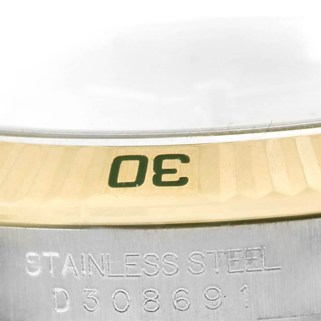 This is a close-up view of the bezel and part of the case back of a Rolex Turn-o-Graph 116263 Men
s Stainless Steel Champagne Dial 116263 Men
s Stainless Steel Champagne Dial watch.