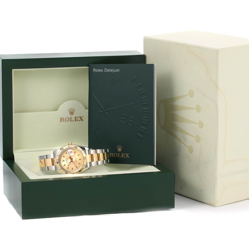 The image shows a Rolex Turn-o-Graph 116263 Men
s Stainless Steel Champagne Dial 116263 Men
s Stainless Steel Champagne Dial watch, its box, and accompanying booklet from an angle displaying the front of the package.