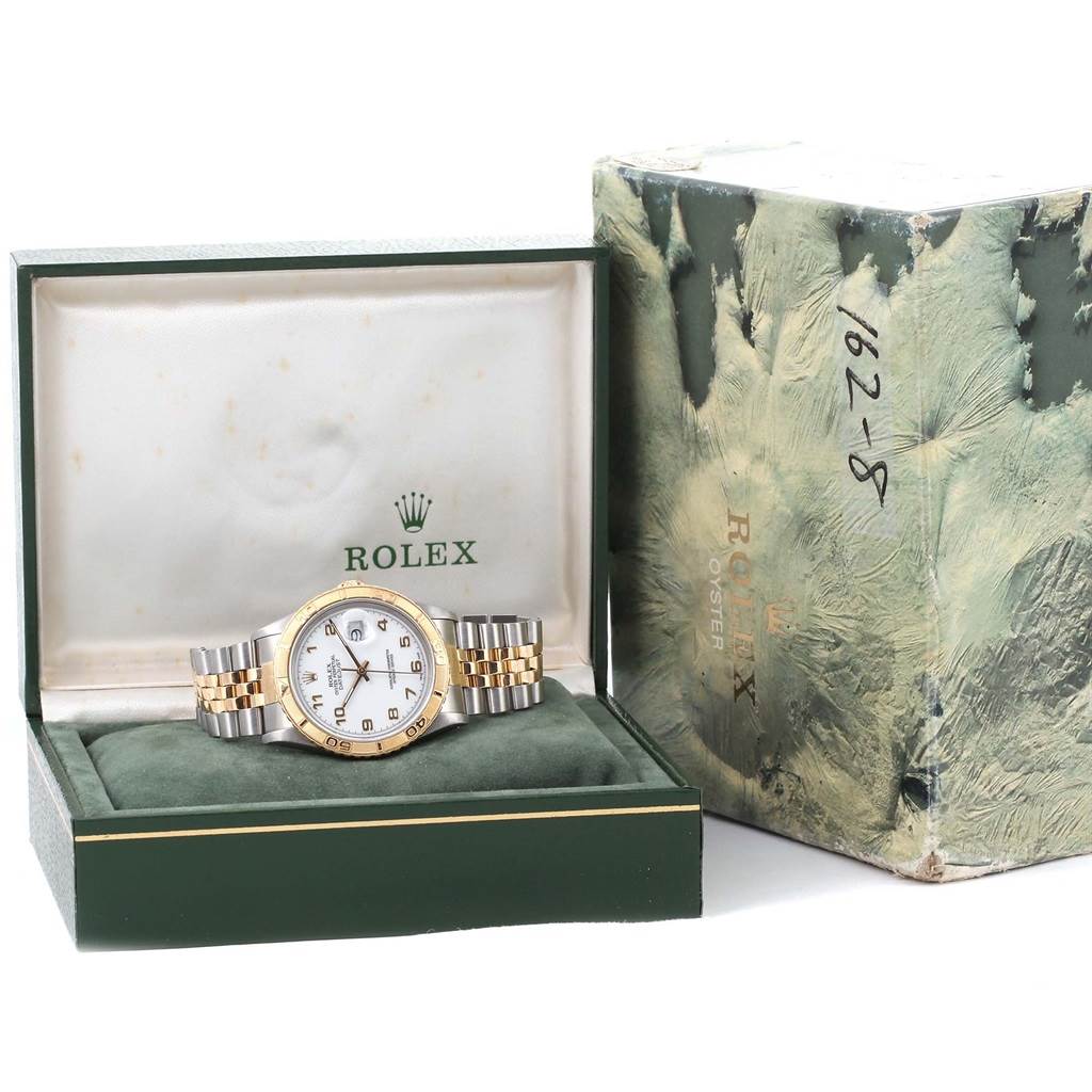 The image shows a Rolex Turn-o-Graph 16263 Men
s Steel and Gold (two tone) White Dial 16263 Men
s Steel and Gold (two tone) White Dial watch positioned frontally in its green box alongside the outer packaging.