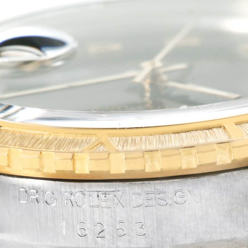 This close-up image of a Rolex Turn-o-Graph 16253 Men's Steel and Gold (two tone) Black Dial 16253 Men's Steel and Gold (two tone) Black Dial watch shows part of the bezel, case, and the engraved model number.
